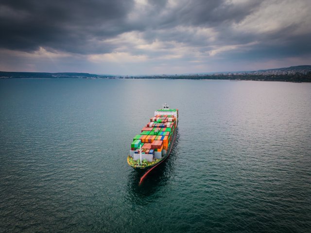 Aerial view of a loaded container ship at sea
