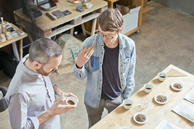 Coffee business owner and customer discussing coffee