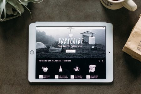Home page of the Four Barrel Coffee responsive website shown on an iPad.