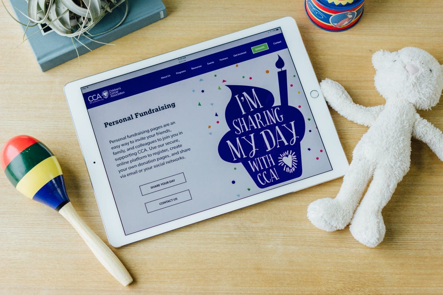 The Children's Cancer Association's responsive website shown on an iPad.