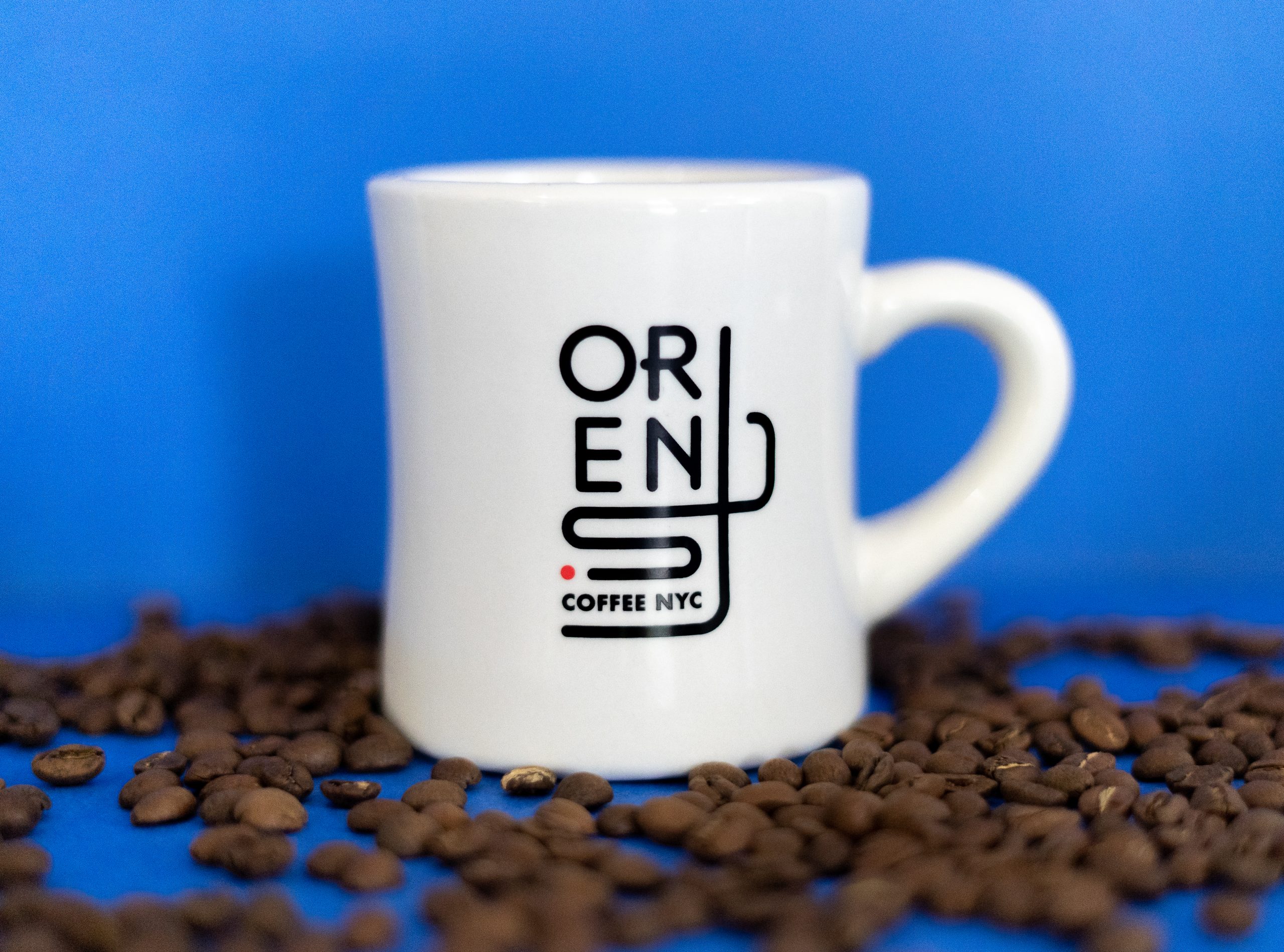 Up close view of a diner mug with the new Orens logo